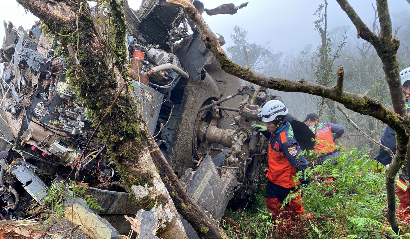 A rescue team searches the helicopter’s wreckage. Photo: Reuters