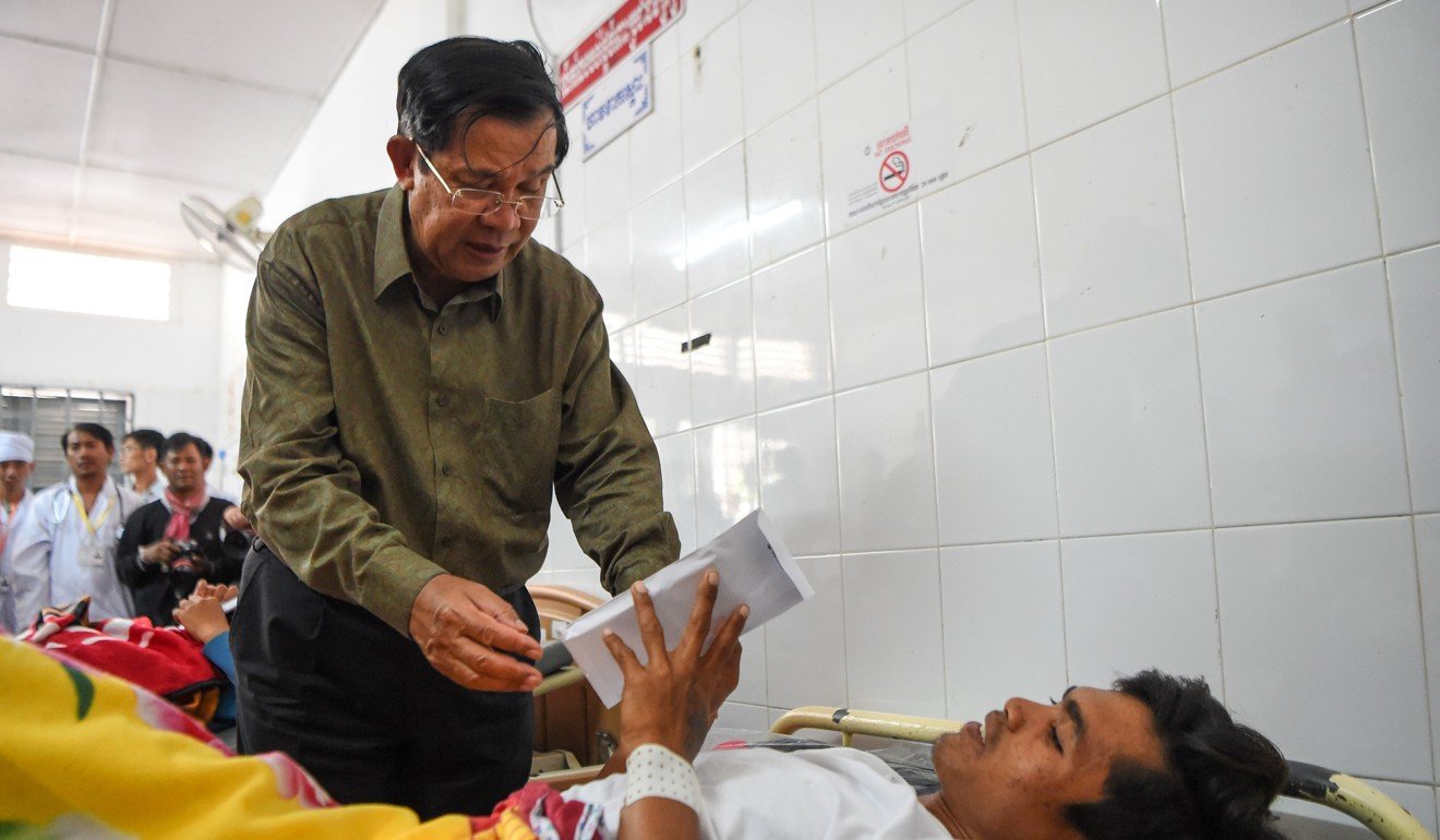 Cambodian Prime Minister Hun Sen visits one of the injured at a hospital in Kep province. Photo: AFP
