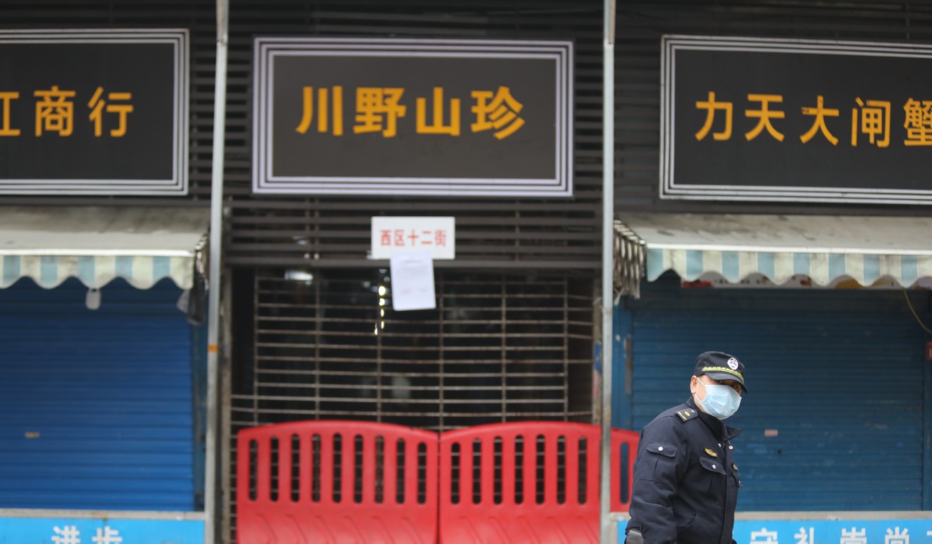 A security patrol outside the Wuhan Huanan Seafood Wholesale Market, which has been identified as the site of the outbreak. Photo: Simon Song