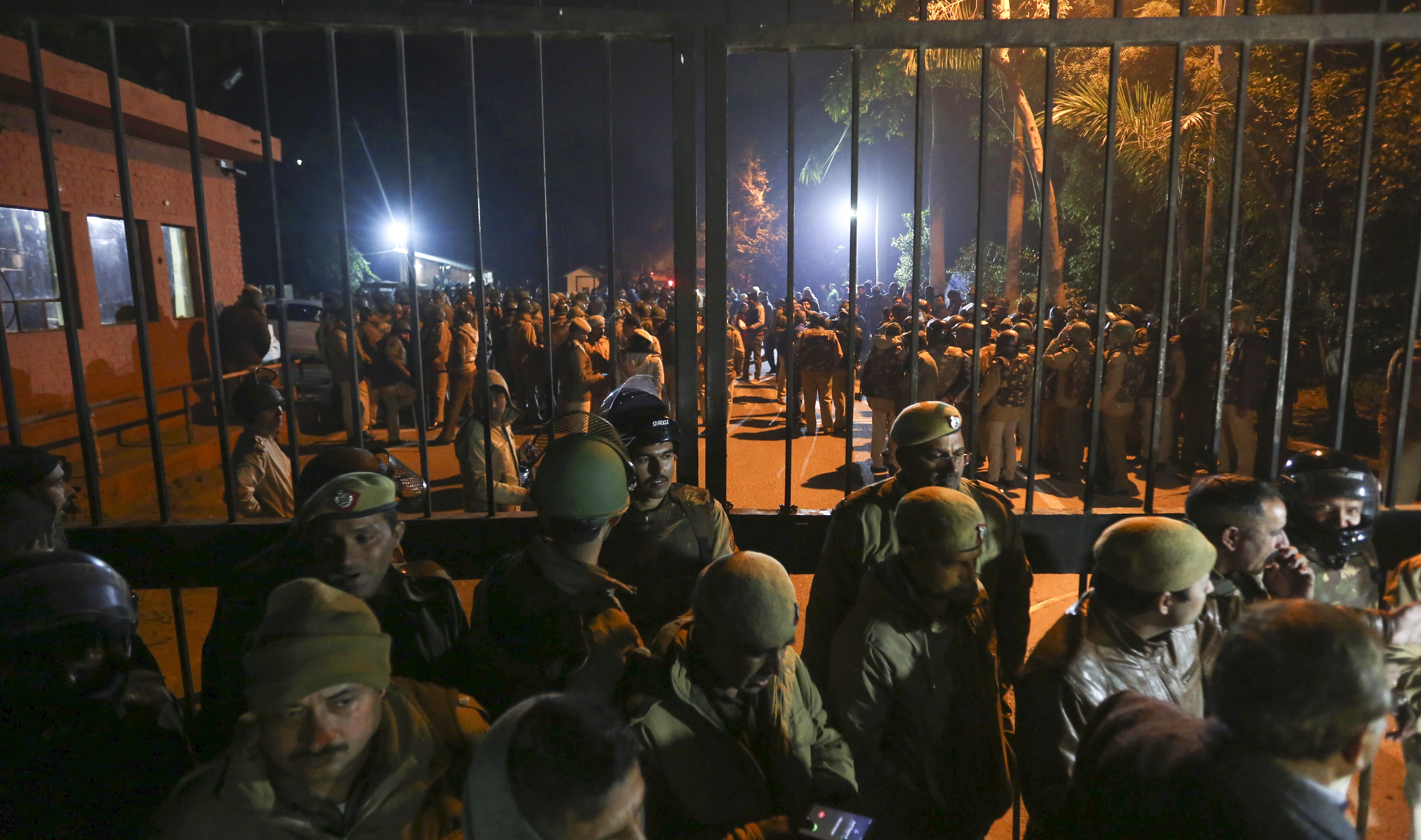 Police arrive at the Jawaharlal Nehru University in New Delhi, India, after masked assailants beat students and teachers with sticks. Photo: AP