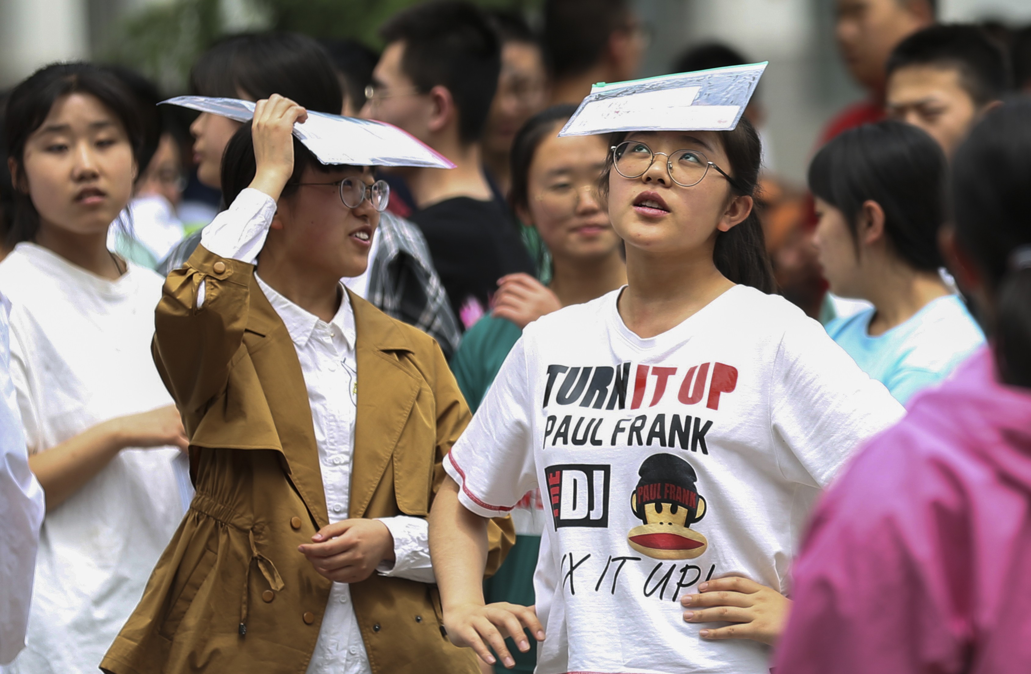 Candidates for gaokao, the all-important university entrance examinations, relax outside an examination venue in Pingliang city, Gansu province last June. China’s education system risks breeding overtrained test takers, rather than innovative thinkers. Photo: Xinhua