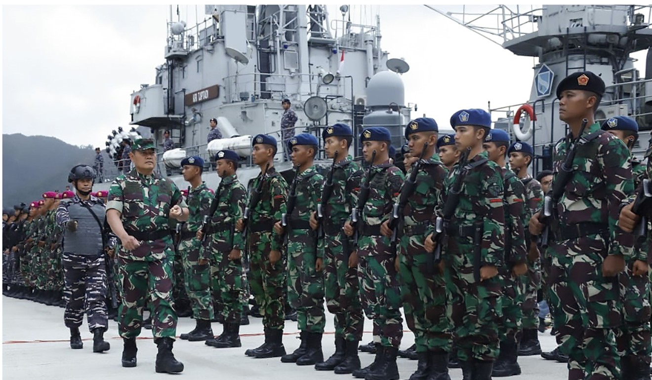 Troops stand to attention at the Natuna military base in Riau islands on January 4, as Indonesia steps up sea and aerial patrols near the disputed South China Sea. Photo: AFP