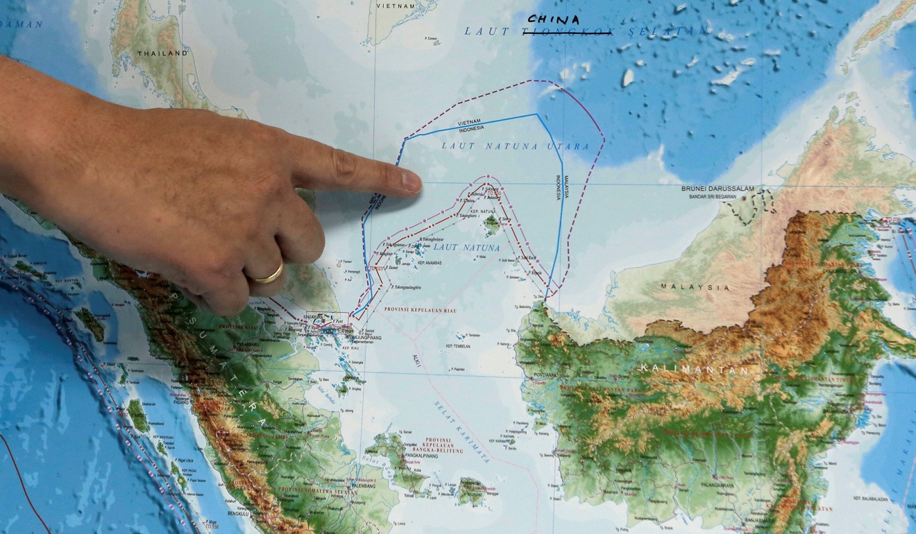 Indonesia's Deputy Minister for Maritime Affairs Arif Havas Oegroseno points at the location of North Natuna Sea on a new map of Indonesia. Photo: Reuters