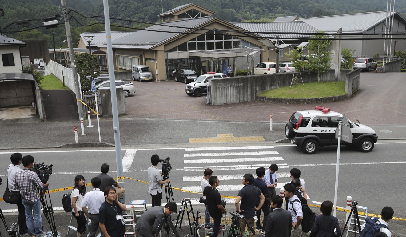 Journalists gather in front of Tsukui Yamayuri-en after the murders in 2016. Photo: AP
