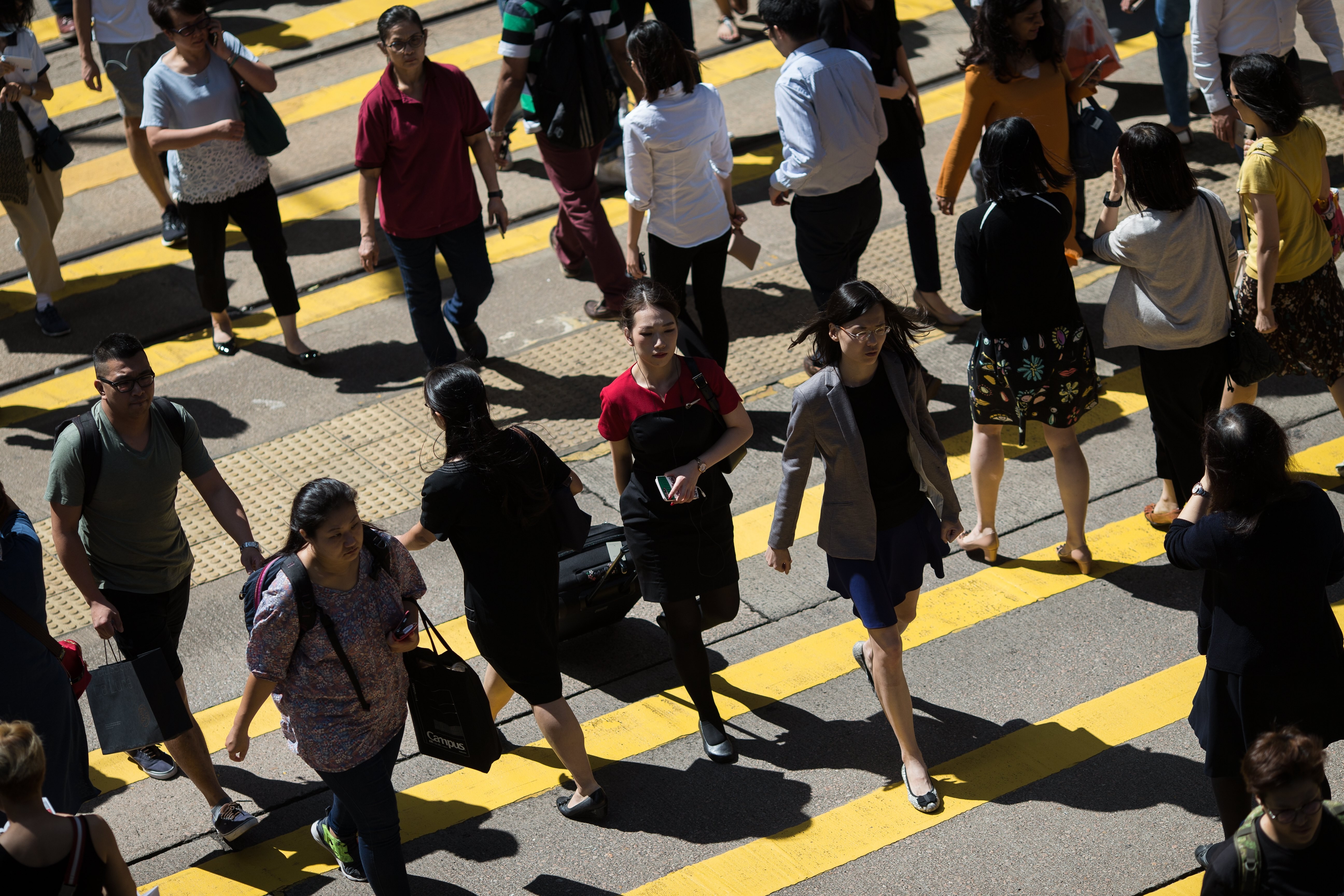 Pedestrians cross an intersection in Central district in Hong Kong on 18 October 2017. Photo: EPA-EFE