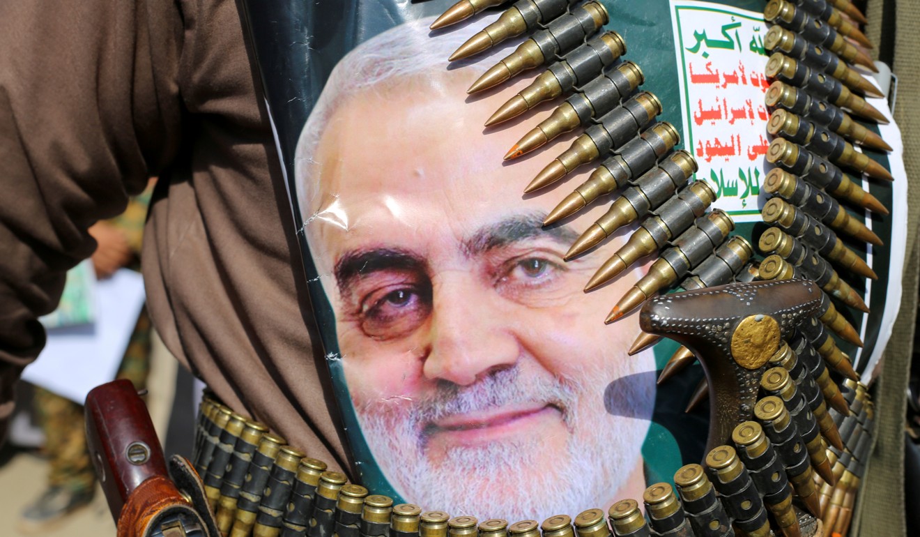 A Houthi rebel in Yemen with a poster attached to his waist of Iranian General Qassem Soleimani. Photo: Reuters