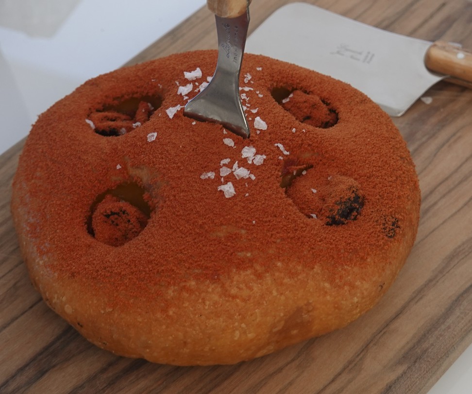 Bread filled with roasted cherry tomatoes and dusted with lycopene served at El Invernadero. Photo: Jeff Koehler