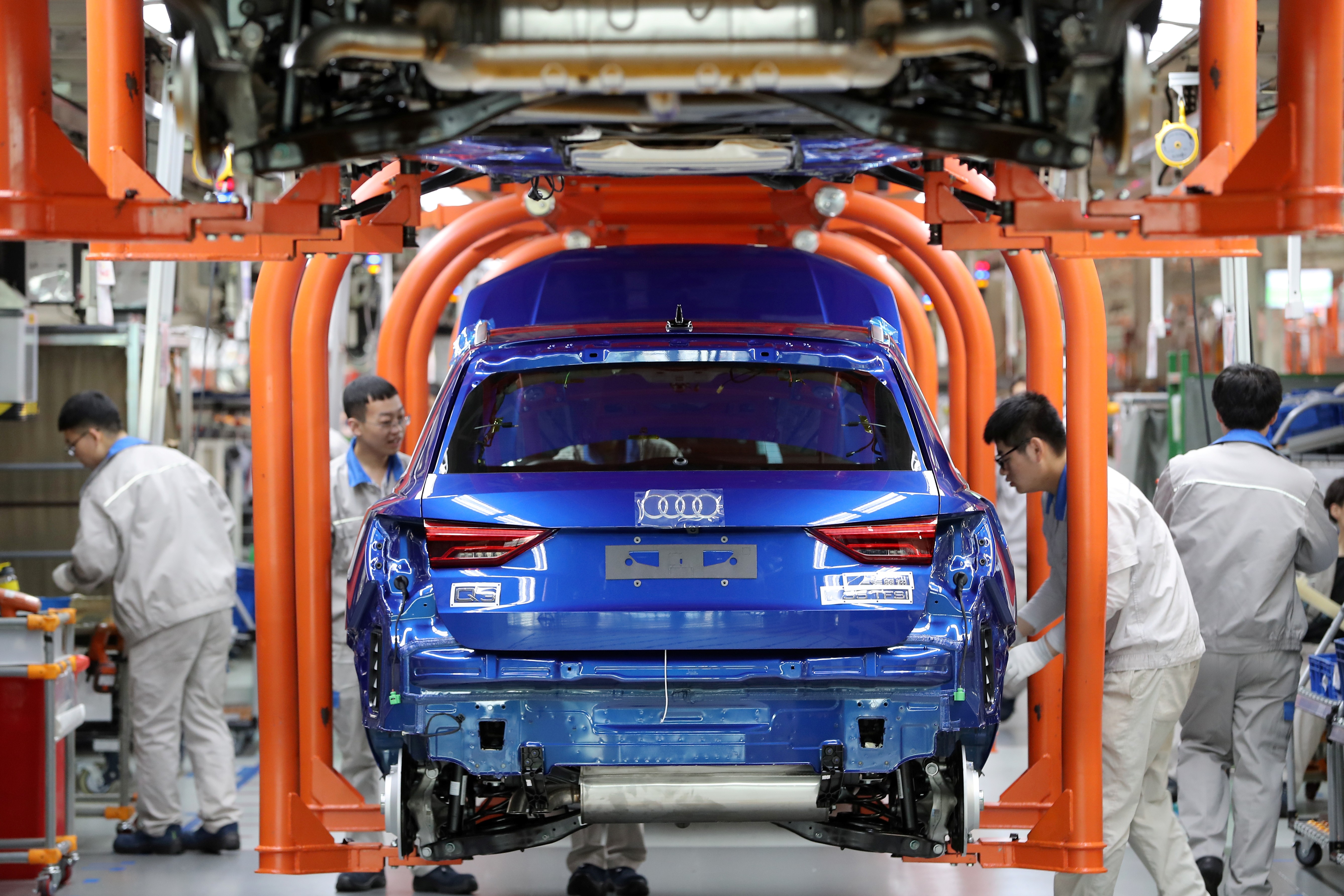 Workers on an assembly line for Audi Q3 cars at the FAW-Volkswagen Tianjin plant in Tianjin, China, on December 5, 2019. Photo: Reuters