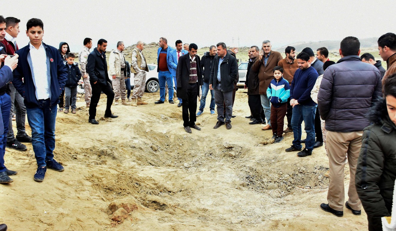 Iraqi Kurds inspect a crater caused by an Iranian missile initially fired at Iraqi bases housing US and other US-led coalition troops, in the Iraqi Kurdish town of Bardarash. Photo: AFP