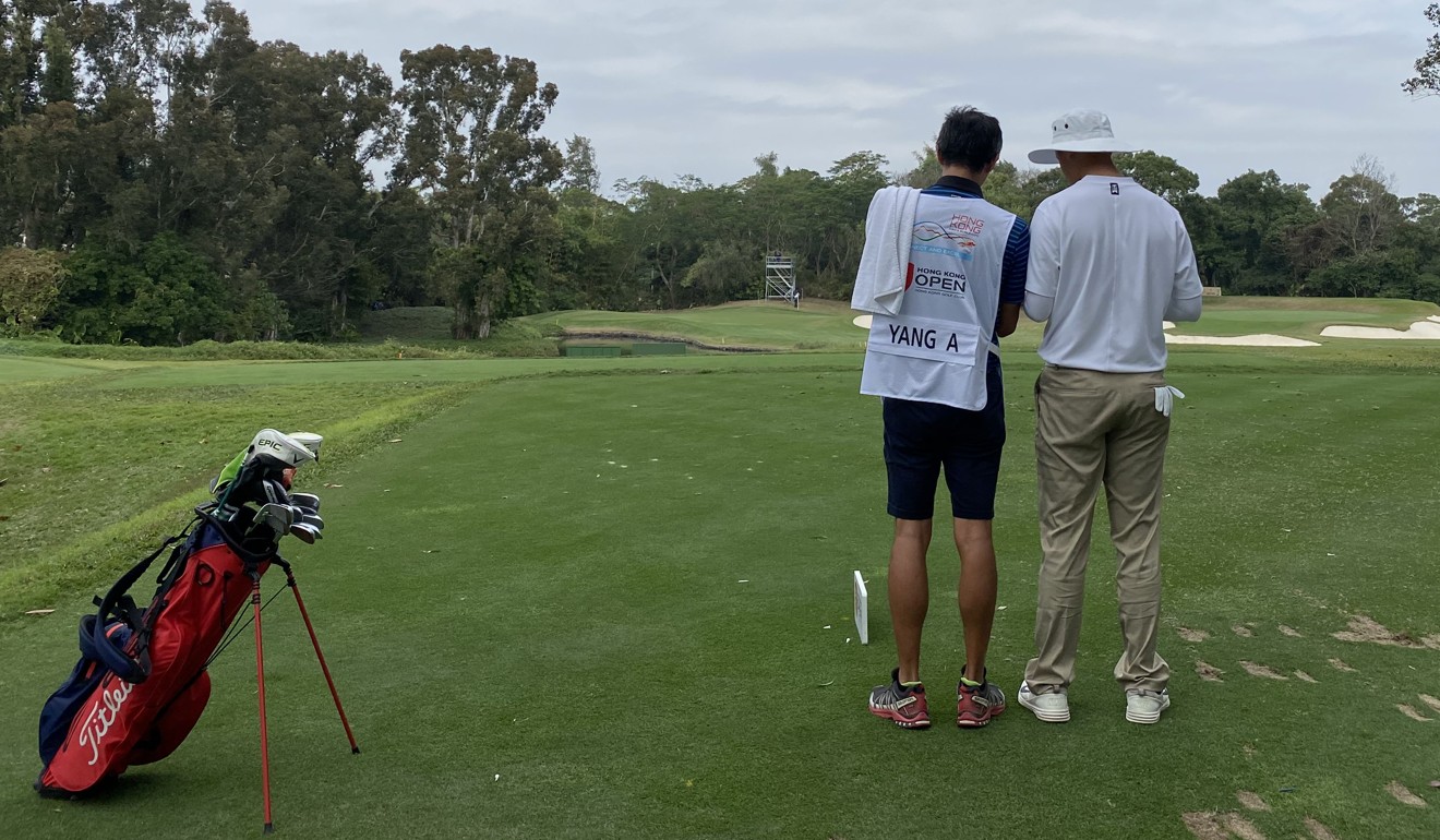 Alexander Yang discusses his approach to the 12th hole with his caddie. Photo: SCMP