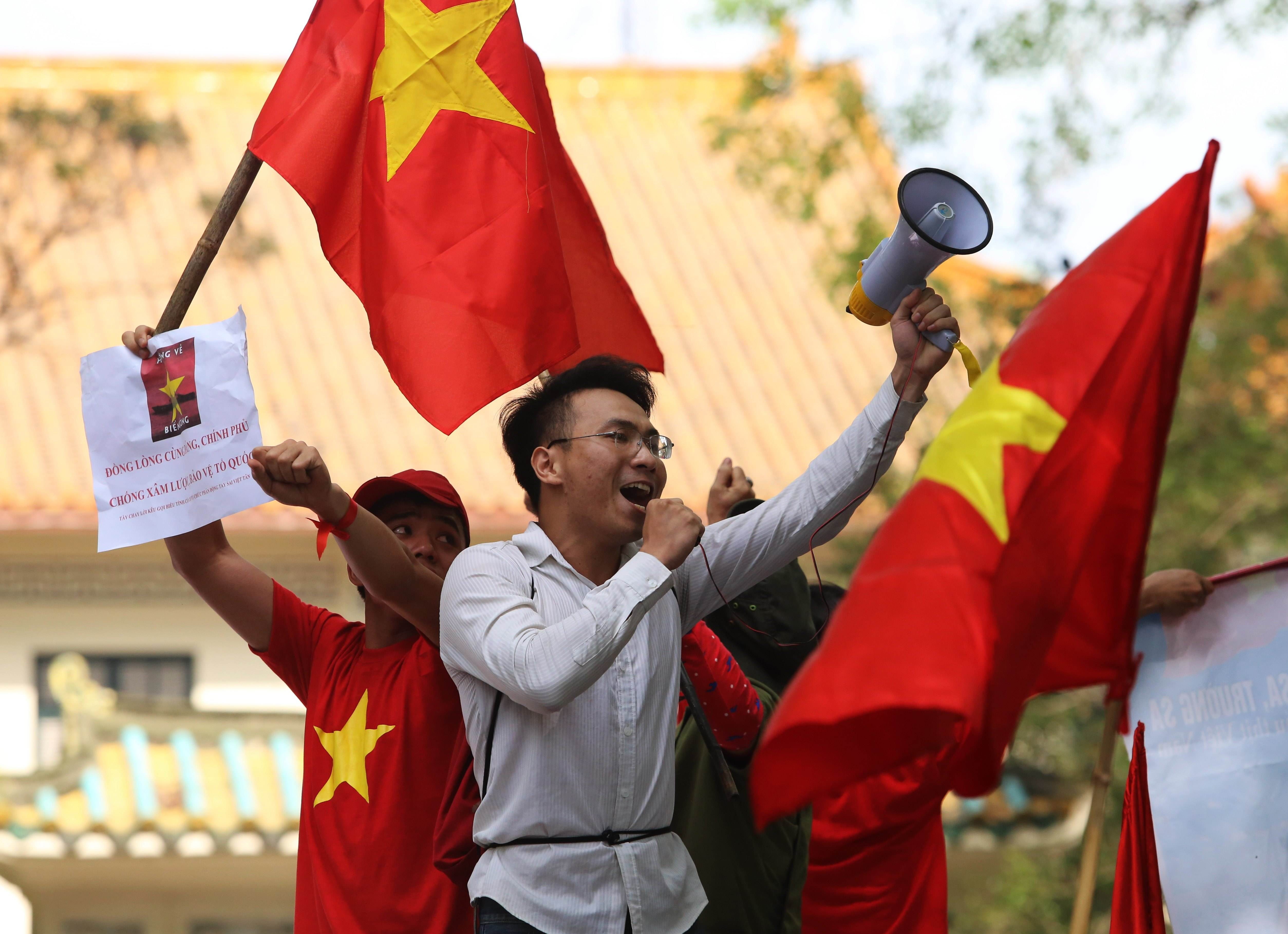 Anti-China protesters wave Vietnamese flags and shout slogans in front of the Chinese embassy in Hanoi. Photo: AFP