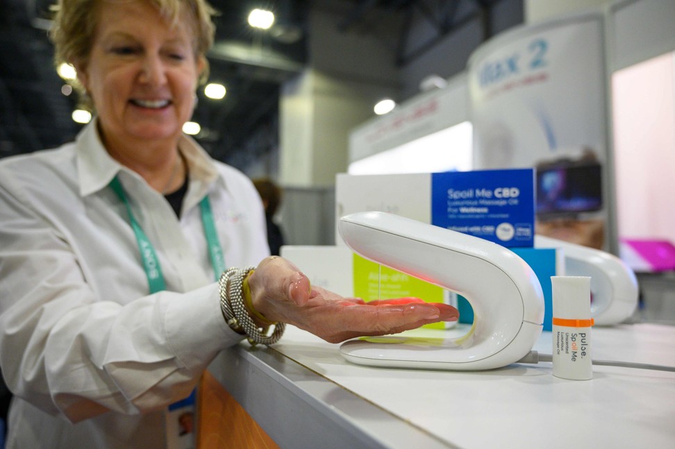 Amy Buckalter, CEO and founder of Pulse, demonstrating the Pulse personal lubricant dispenser at CES 2020. Photo: AFP