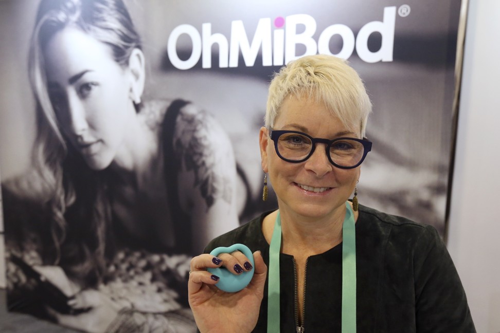 Suki Dunham, co-founder of OhMiBod, holding one of her sexual health pleasure devices designed for seniors at CES 2020. Photo: AP