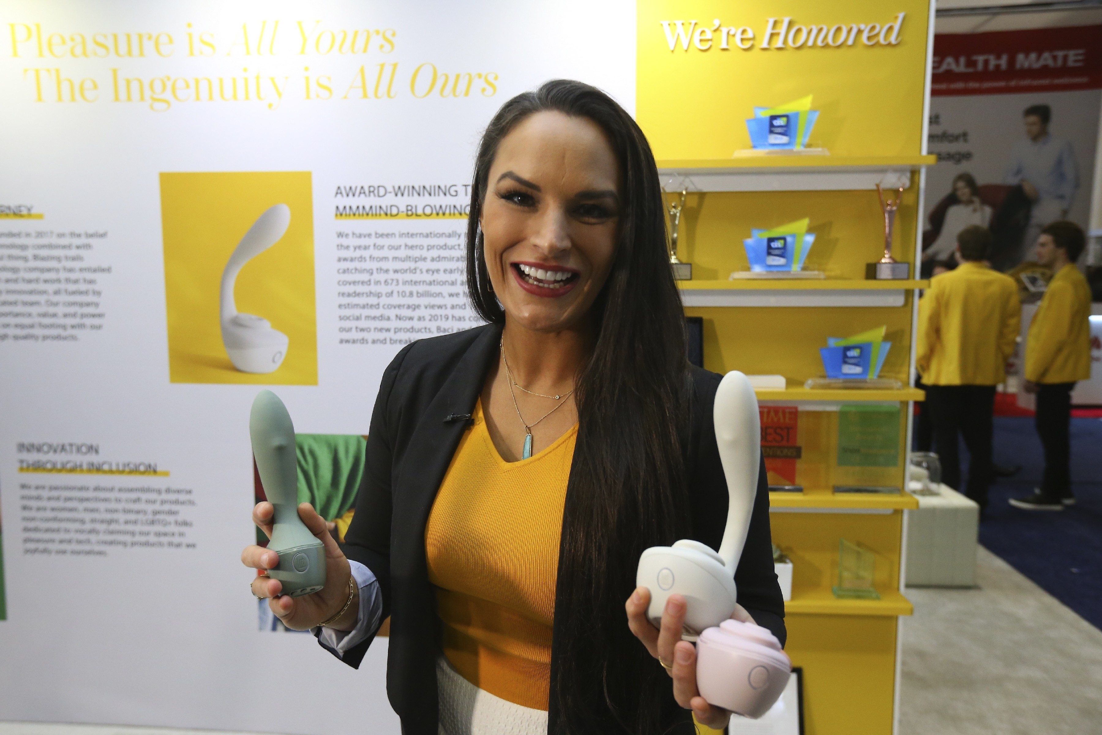 Lora Haddock DiCarlo, founder and CEO of Lora DiCarlo, holding several of her robotic massager devices at CES 2020. Photo: AP