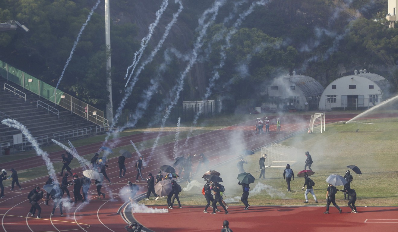 Clashes erupt between anti-government protesters and riot police in a sports field at Chinese University. Photo: Winson Wong
