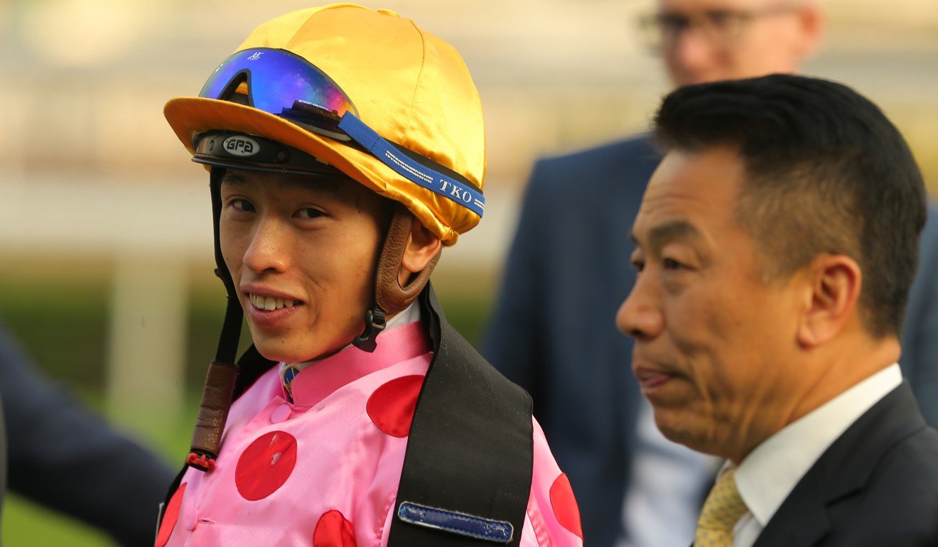 Trainer Ricky Yiu (right) and jockey Vincent Ho celebrate Preciousship’s victory.