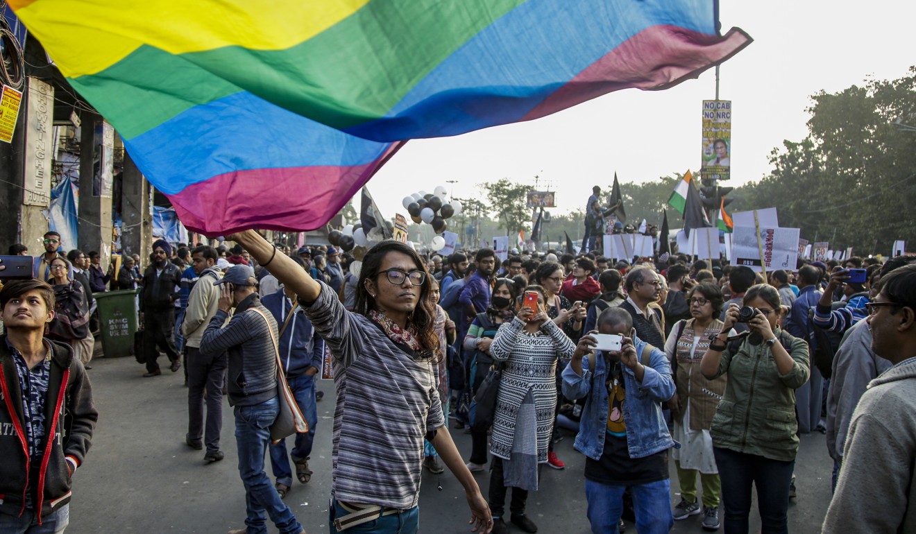 An activist of the LGBTQ community waves a rainbow flag during a protest a new citizenship law and against the visit of Prime Minister Narendra Modi's visit, in Kolkata, India. Photo: AP Photo