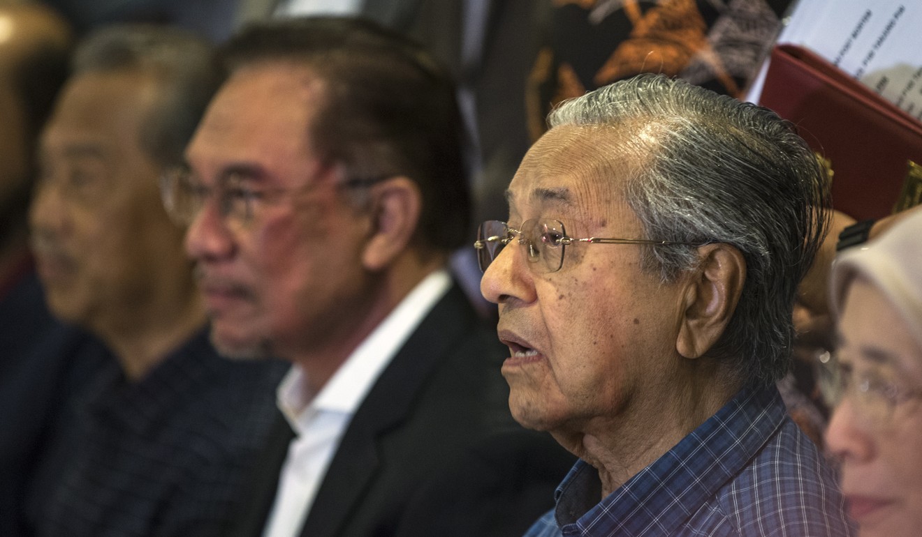 Malaysian Prime Minister Mahathir Mohamad, right, has said he will hand over power to Anwar Ibrahim – but has not specified when. Photo: EPA