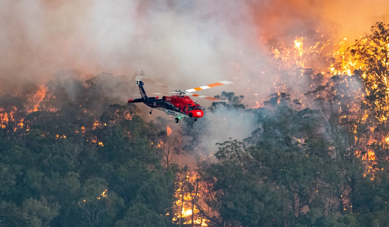 A firefighting helicopter in the East Gippsland region of Victoria. Photo: AAP/ DPA