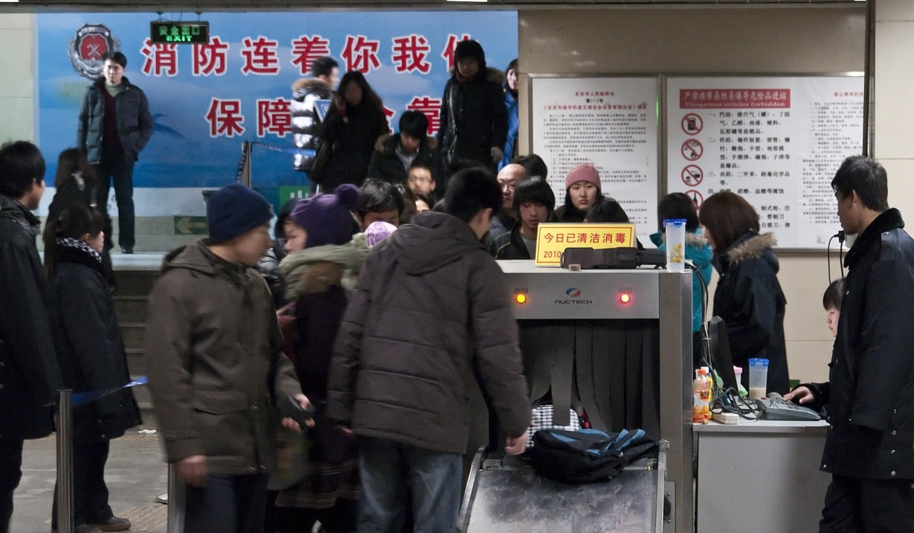 Passengers go through security checks at the Dongzhimen subway station in Beijing. Photo: AFP