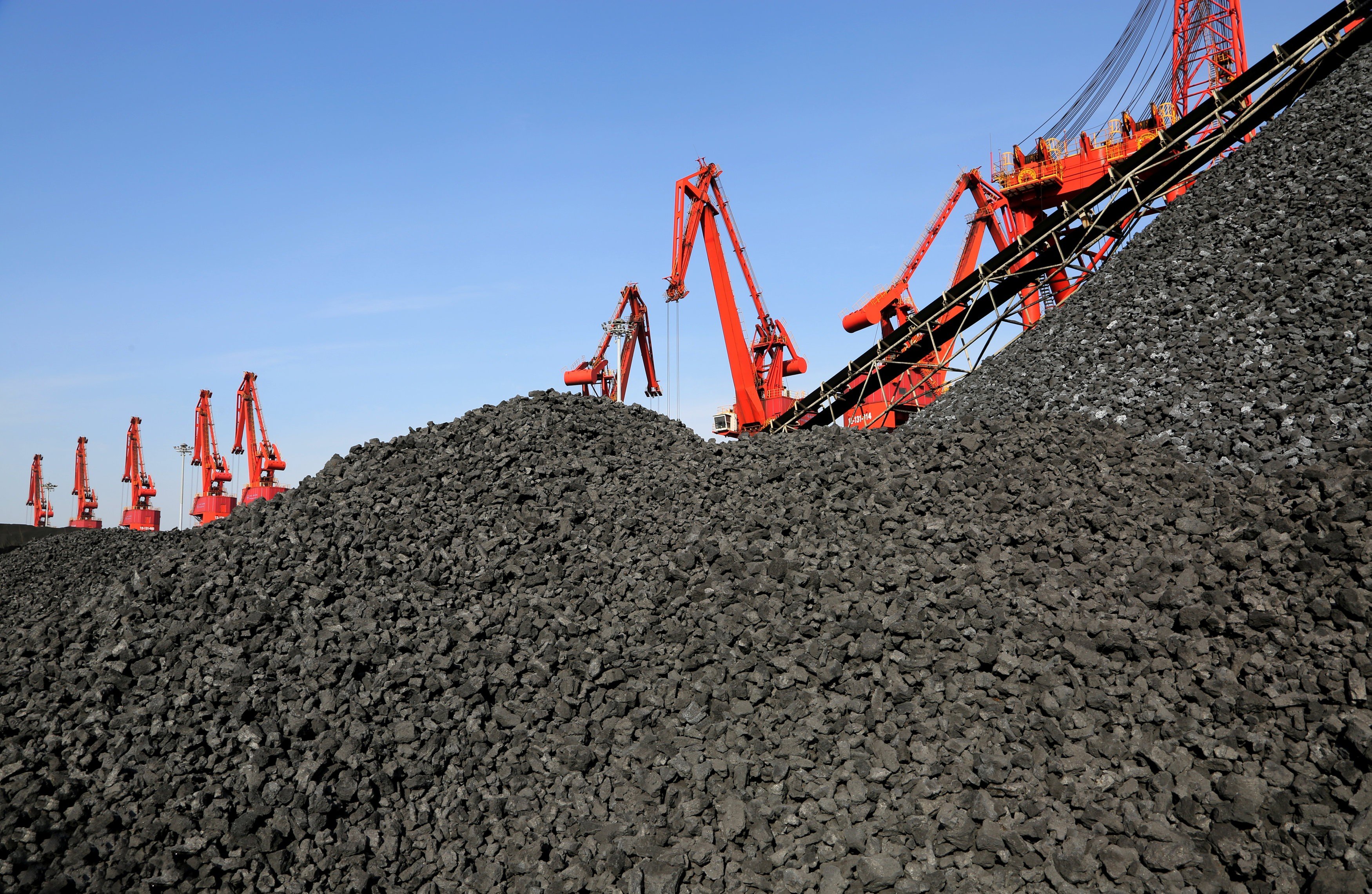 Cranes unload coal from a cargo ship at a port in Lianyungang, Jiangsu province, China. Thermal coal producers will come under more scrutiny from BlackRock. Photo: Reuters