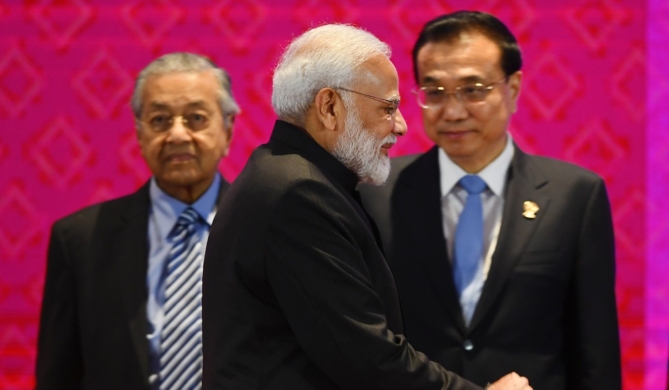 India's Prime Minister Narendra Modi walks past Malaysia's Prime Minister Mahathir Mohamad (L) and China's Premier Li Keqiang (R) during the 14th East Asia Summit in Bangkok in November 2019, on the sidelines of the Asean summit. Photo: AFP