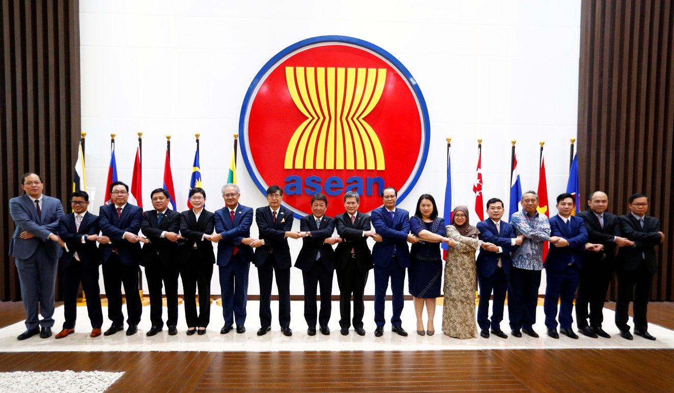 Asean country representatives pose for a family photo at the Asean Secretariat in Jakarta, Indonesia, on January 10. Photo: Reuters