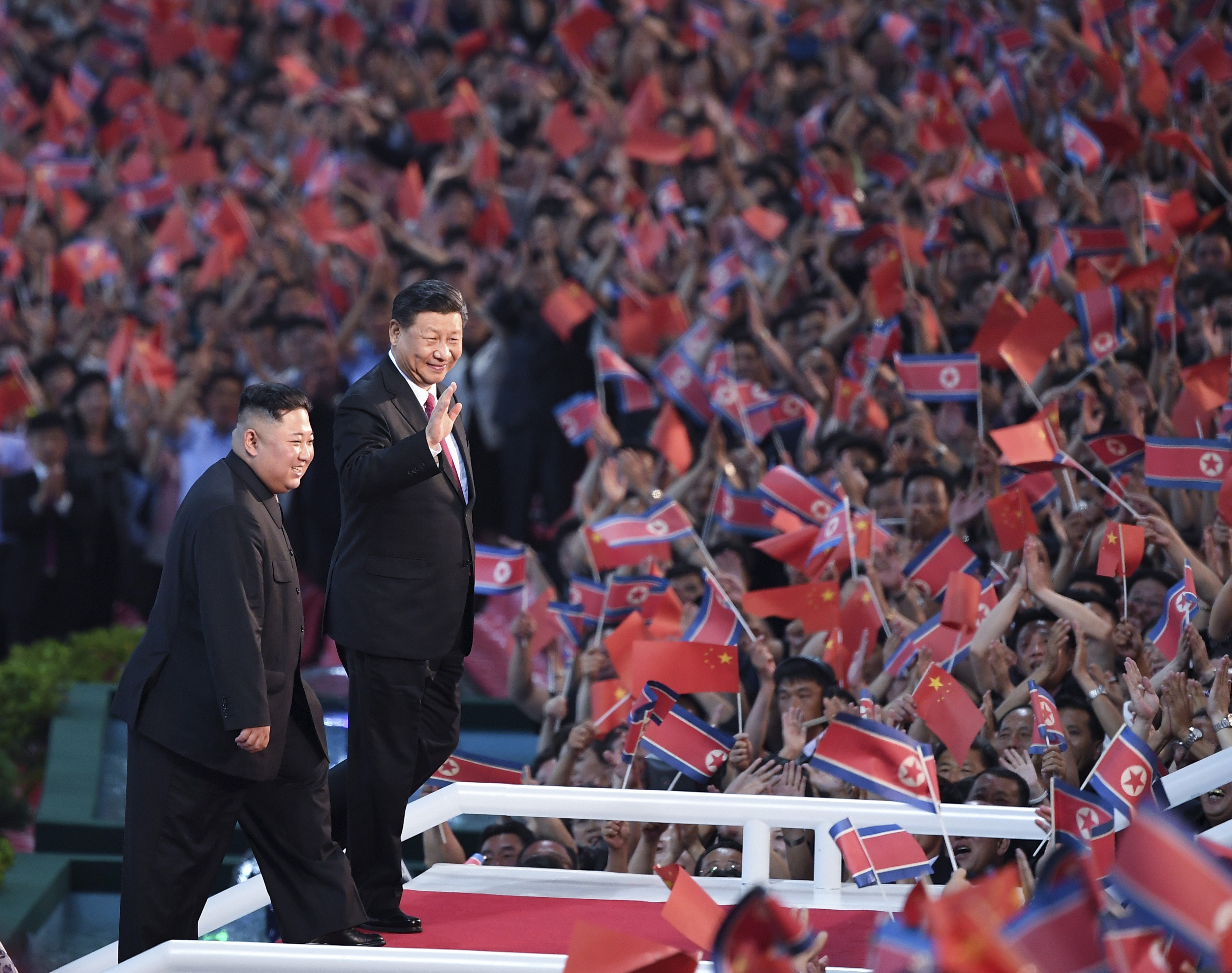 Chinese President Xi Jinping and North Korean leader Kim Jong-un greet the crowds at a performance at the May Day Stadium in Pyongyang on June 20. Beijing’s mediation of nuclear talks would help promote its status as a responsible power on the world stage. Photo: Xinhua