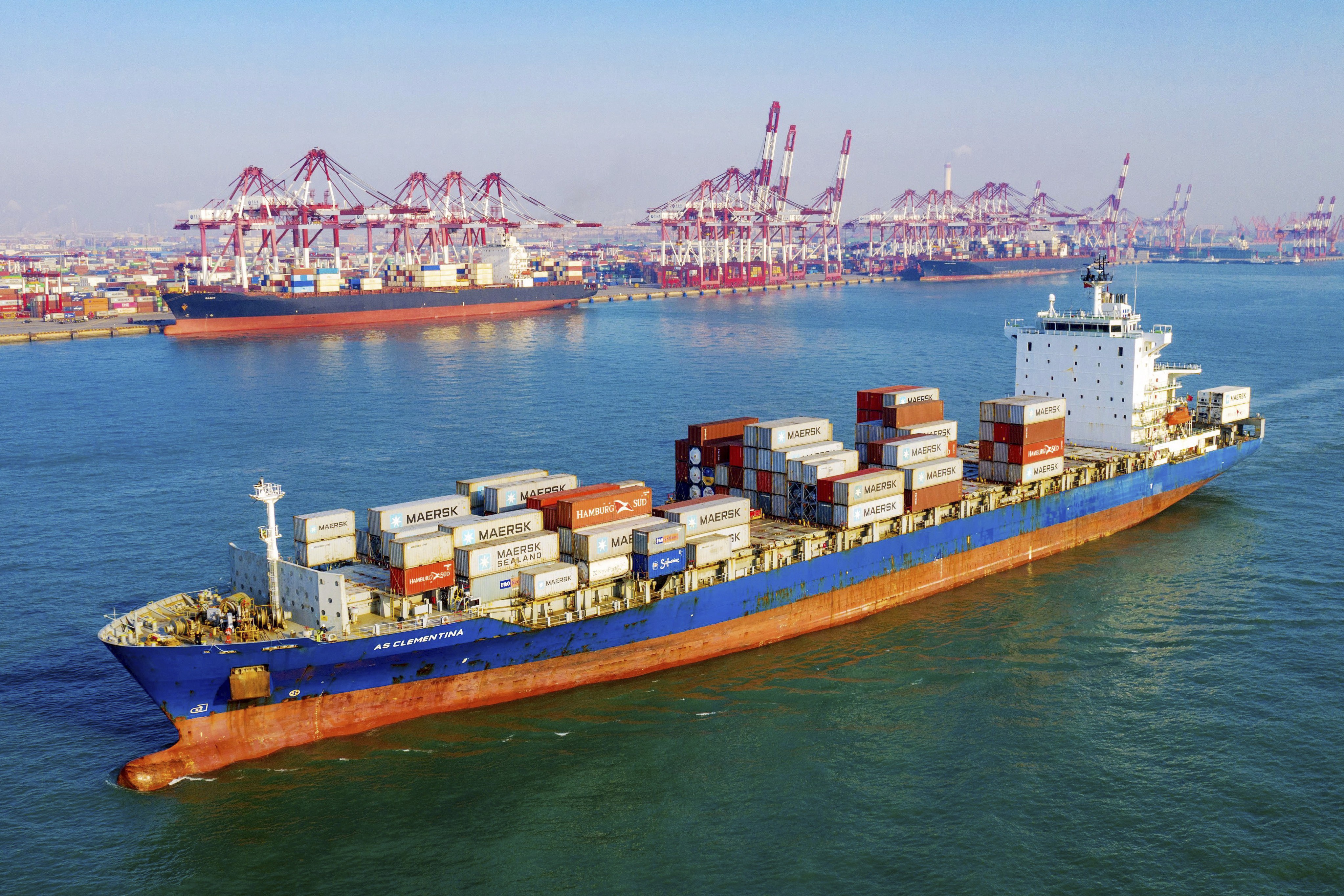 A container vessel moves past the port in Qingdao in eastern China's Shandong province. China's exports rose 0.5% in 2019 despite a tariff war with Washington after growth rebounded in December on stronger demand from other markets. Photo: AP