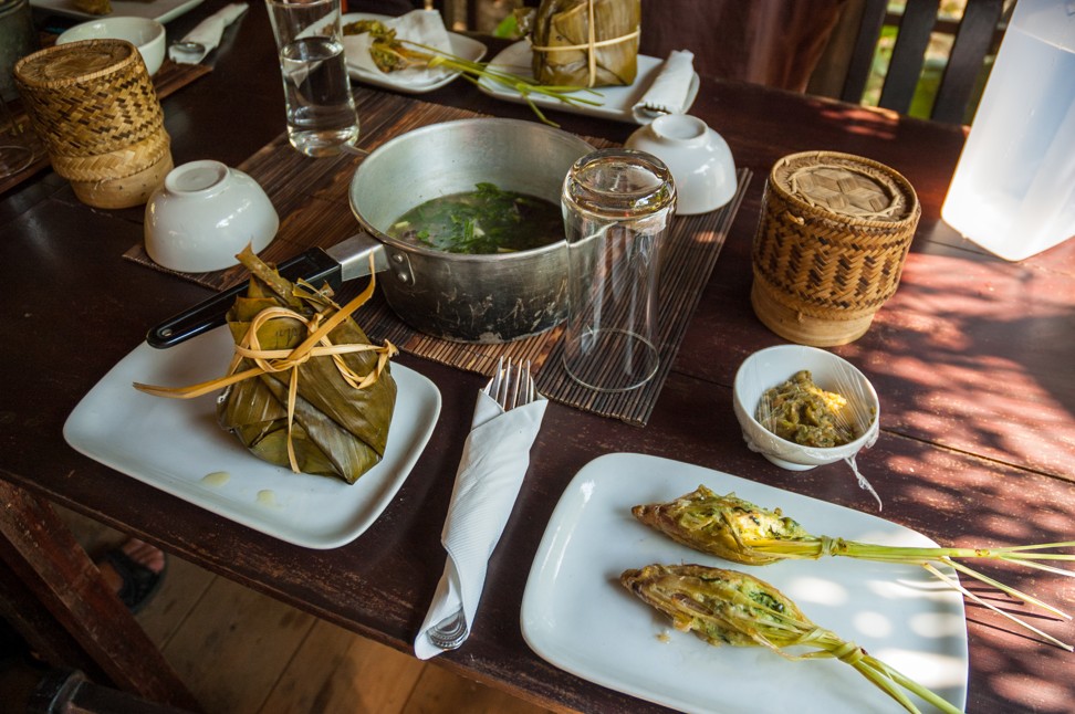 Food at the Tamarind cooking class in Luang Prabang includes mok pa in the banana leaf, orlarm in the pan, and ua si khai deep-fried lemongrass stuffed with minced chicken.
