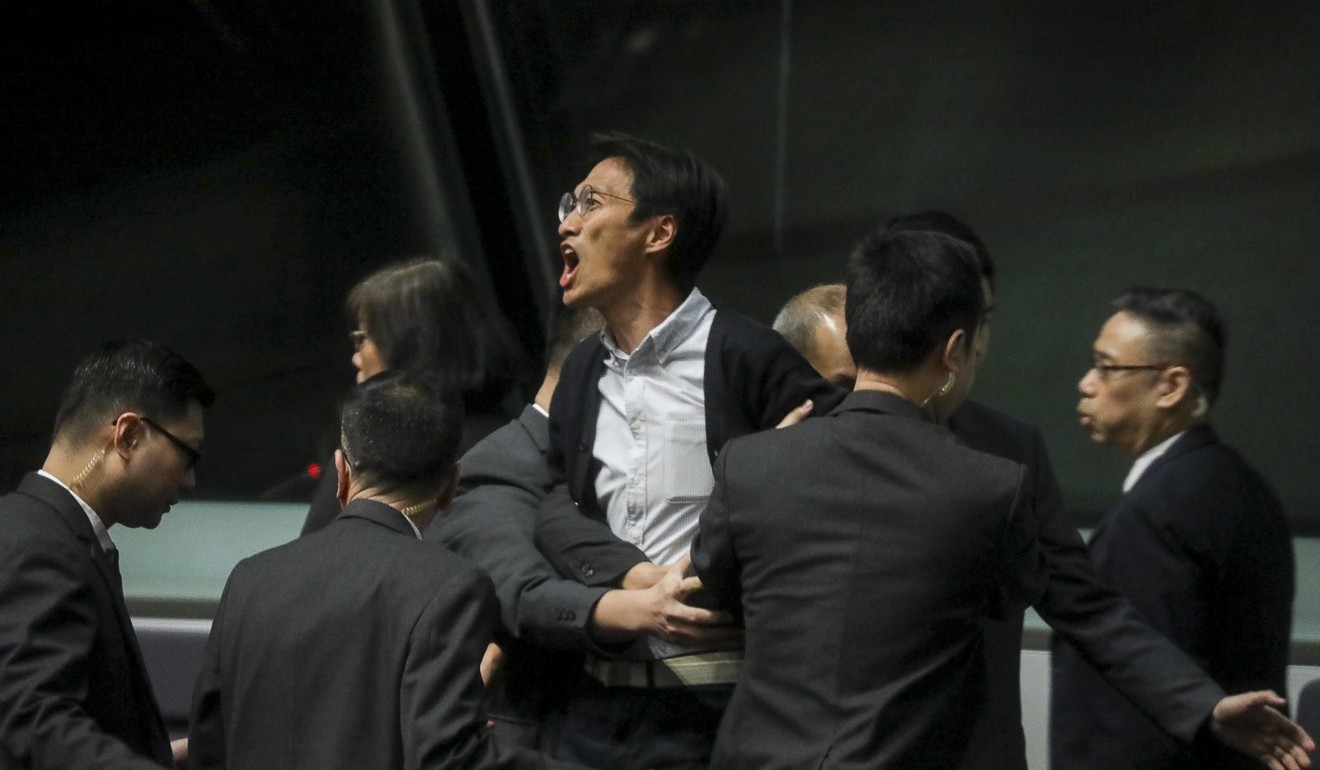 Carrie Lam is heckled by lawmakers including Eddie Chu at the legislature. Photo: Dickson Lee