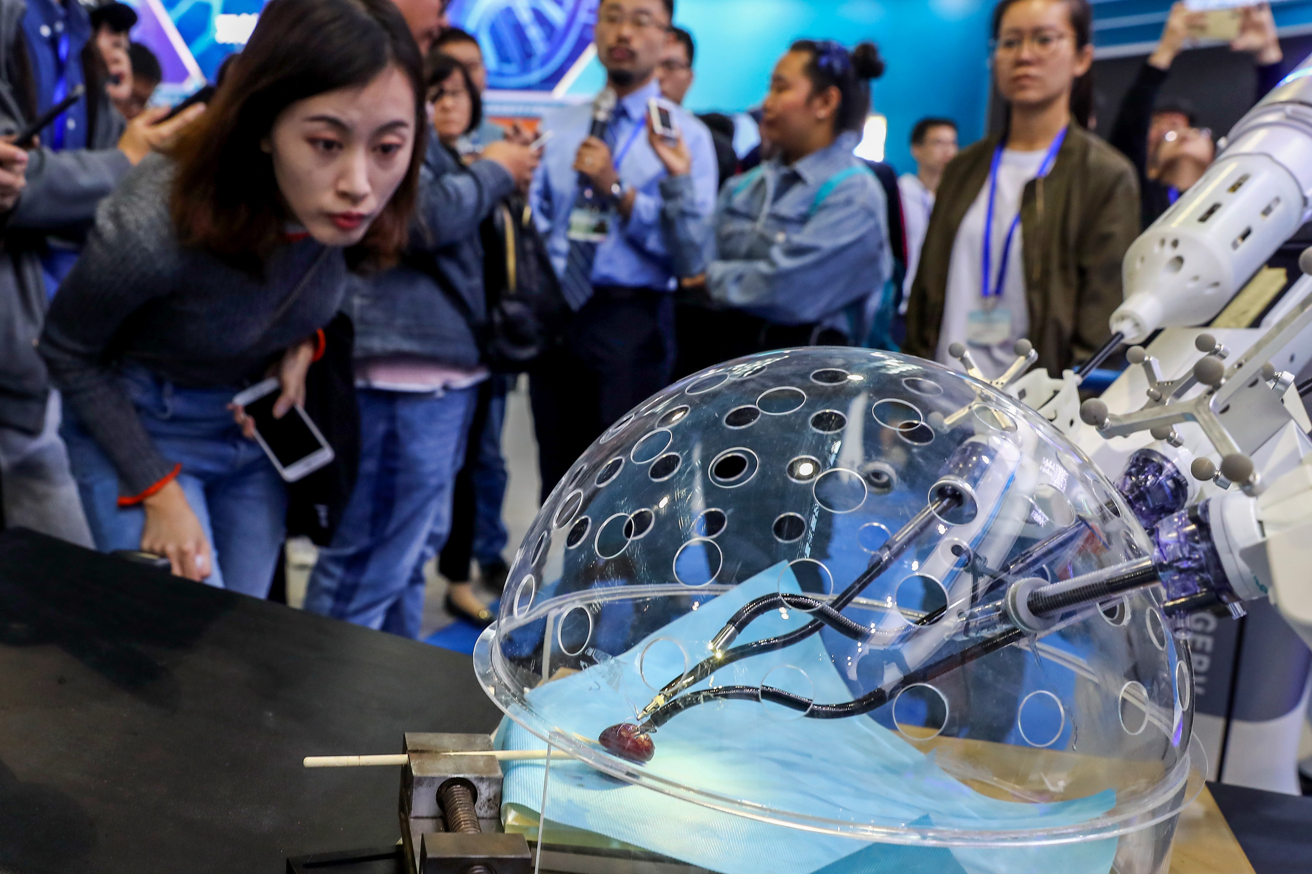 Members of the media look at a robot system for porotic laparoscopic surgery during a preview of the National Mass Innovation and Entrepreneurship Week in Beijing in October 2018. The US has criticised China for intellectual property theft. Photo: Xinhua
