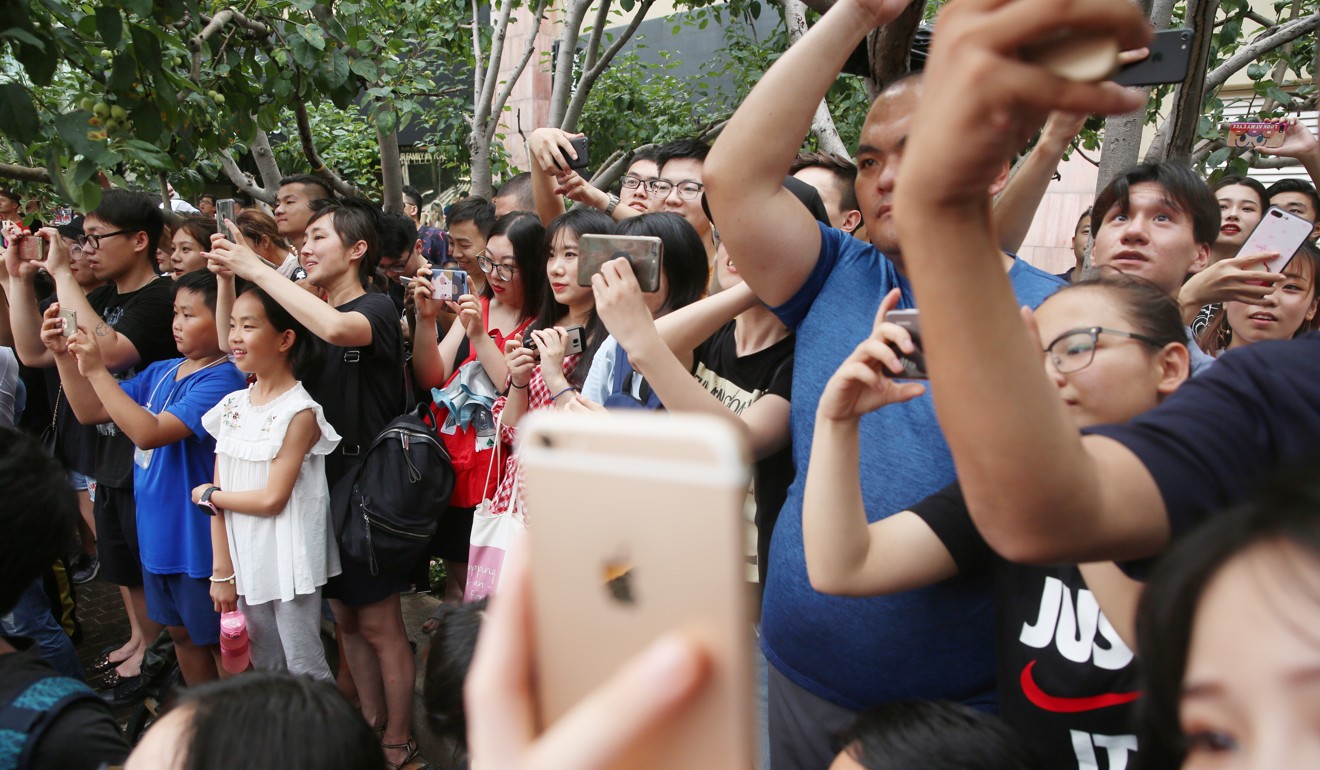 Chinese fans use their mobile phones during a visit by new Juventus soccer player Cristiano Ronaldo in Beijing in 2018. Photo: EPA