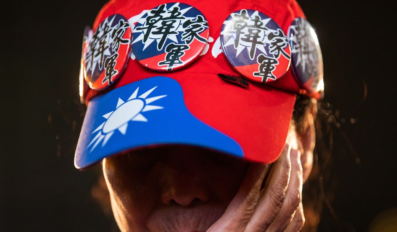 An attendee covers her face during a Kuomintang party rally in Taiwan. Photo: Bloomberg