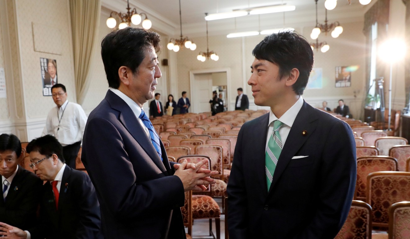 Japan's Prime Minister Shinzo Abe talks with Environment Minister Shinjiro Koizumi. Photo: Reuters