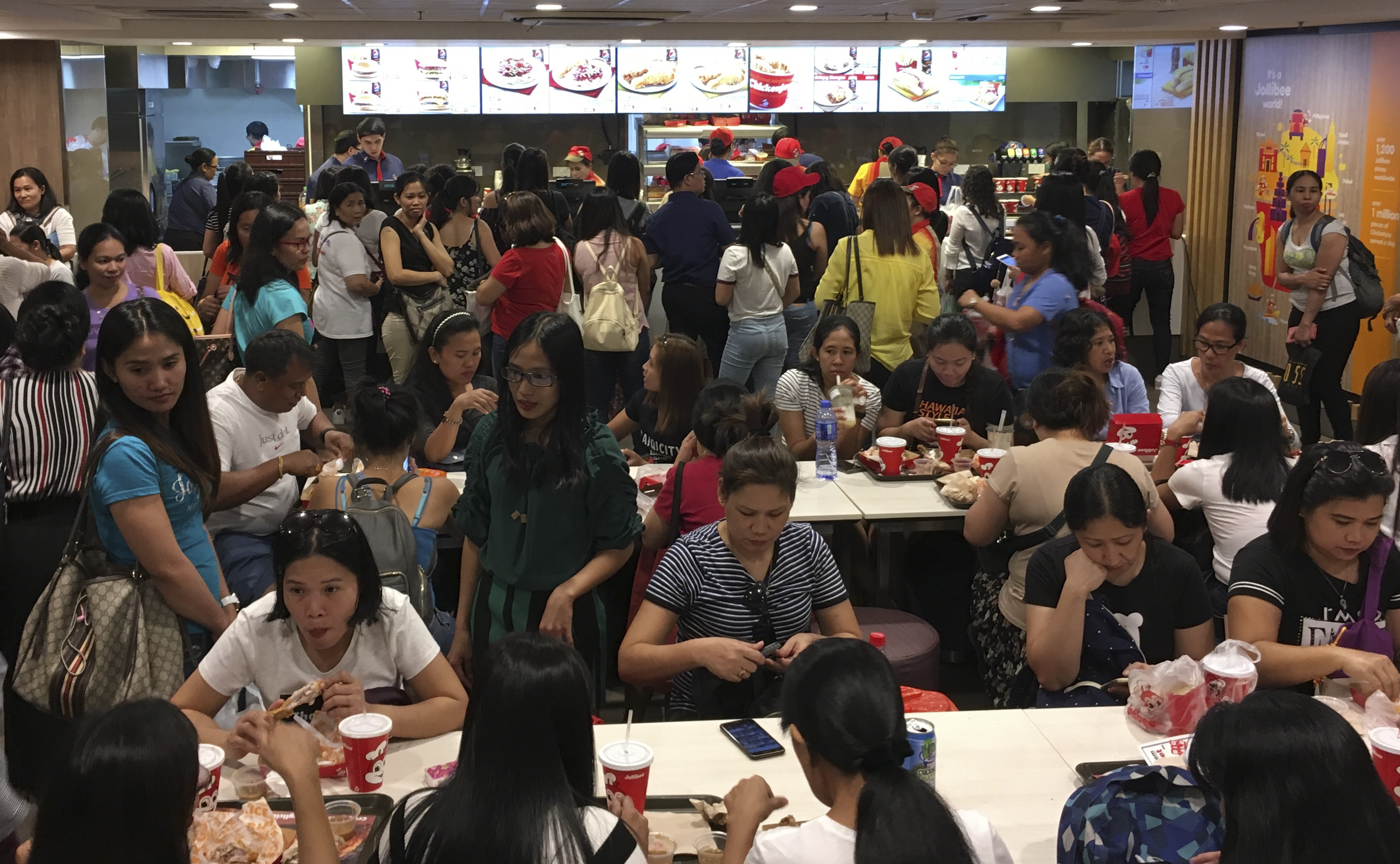 A Jollibee outlet is not just a place to dine in for many Filipino domestic helpers in the city. It is a place to meet, take selfies, and chat with their friends during their holidays. 30SEP18 Photo: Cheryl Arcibal