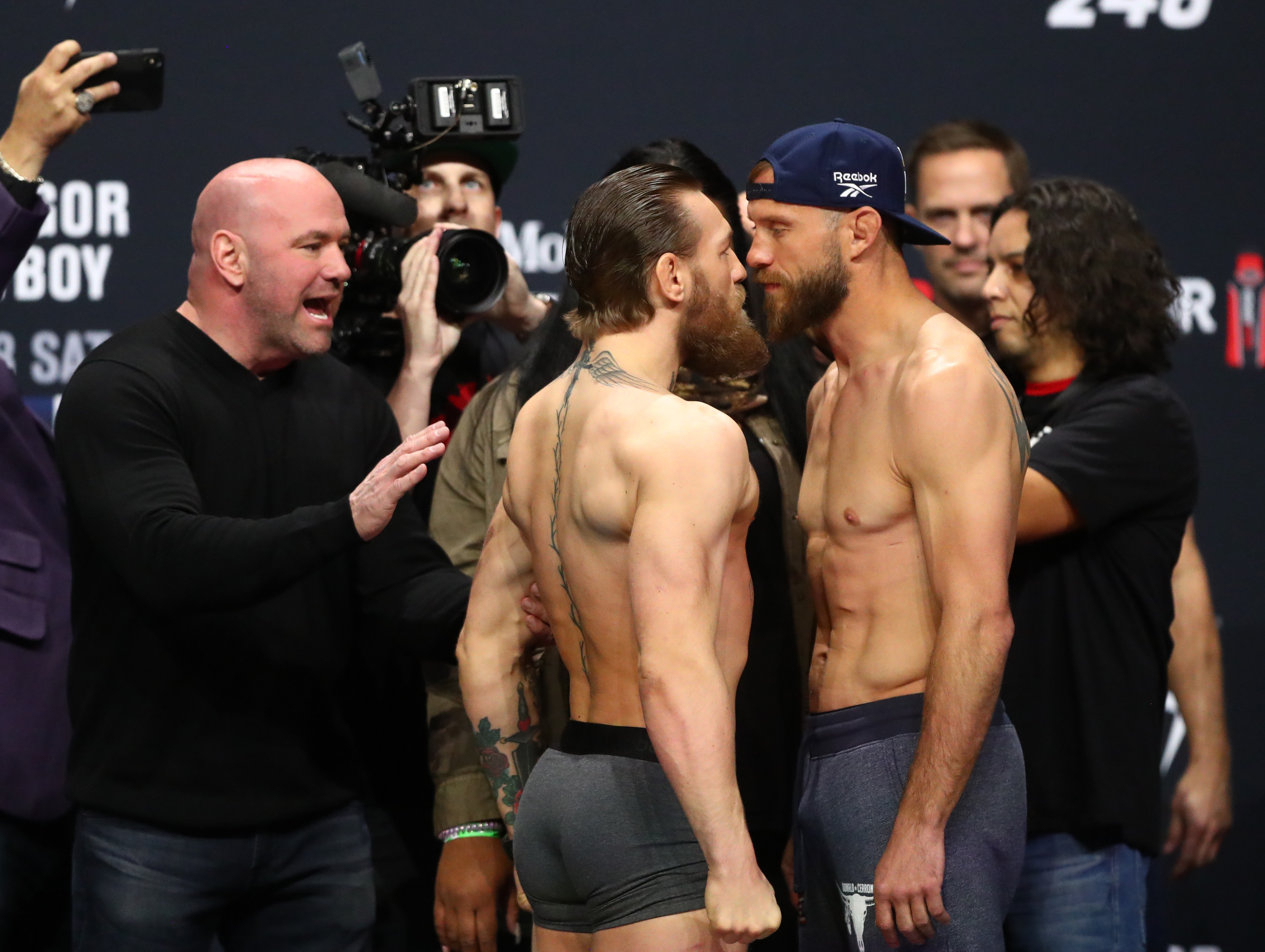 UFC president Dana White (left) reacts as Conor McGregor (centre) faces off against Donald Cerrone during the weigh-ins for UFC 246. Photo: USA TODAY Sports