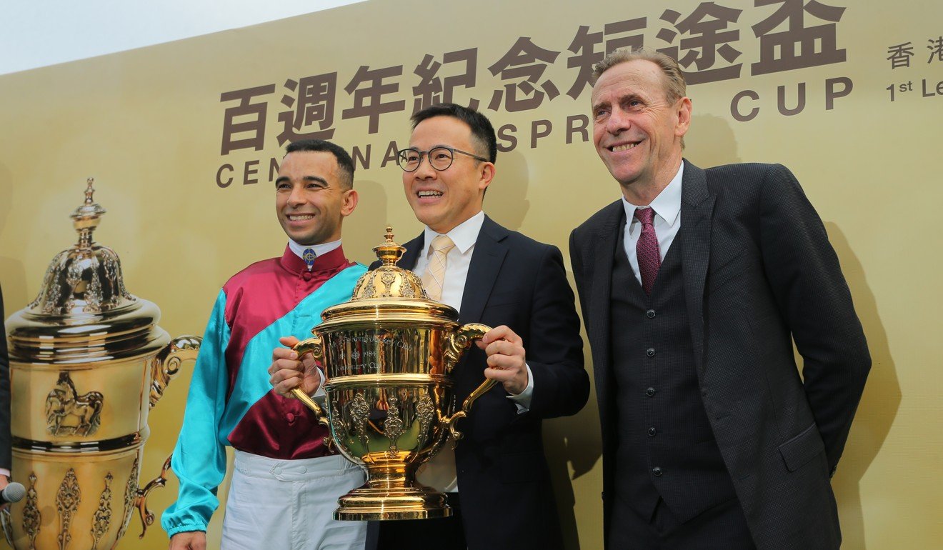 Jockey Joao Moreira (left) and trainer John Size (right) celebrate Beat The Clock’s victory with owner Merrick Chung Wai-lik.