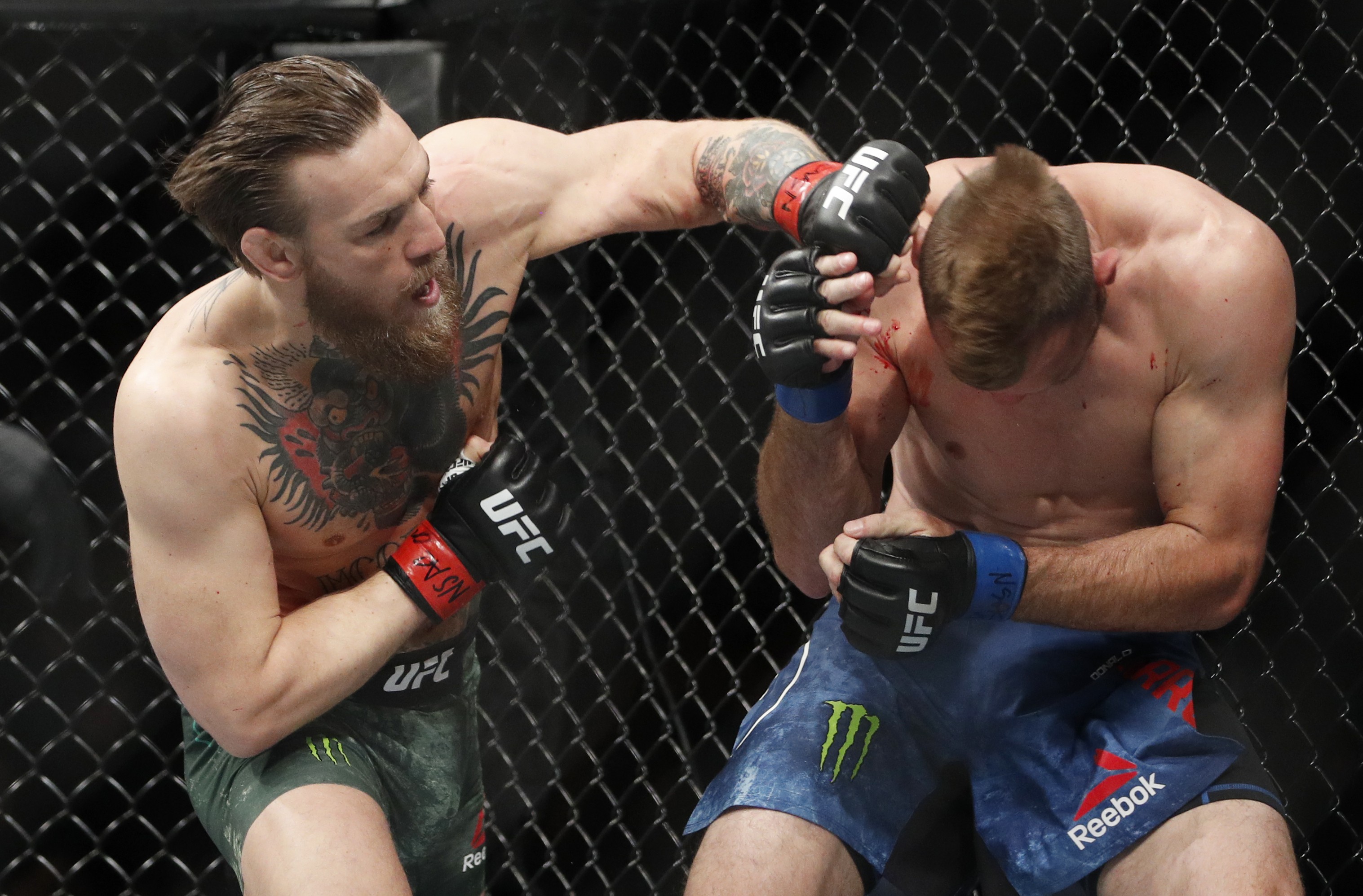 Conor McGregor hits Donald "Cowboy" Cerrone during their UFC 246 main event bout in Las Vegas. Photo: AP