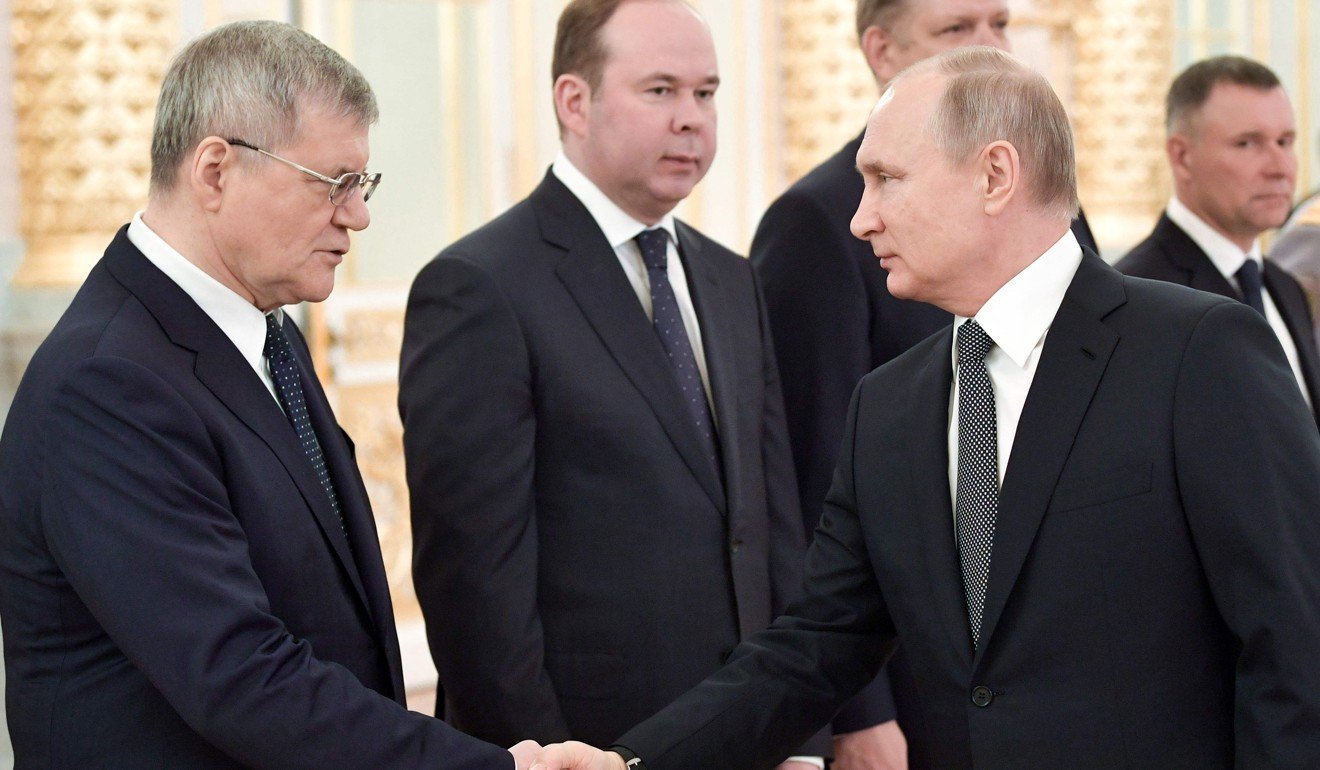 Russian President Vladimir Putin (right) shakes hands with Prosecutor General Yuri Chaika in Moscow in April. Putin removed Chaika on Monday and nominated a replacement. Photo: AFP