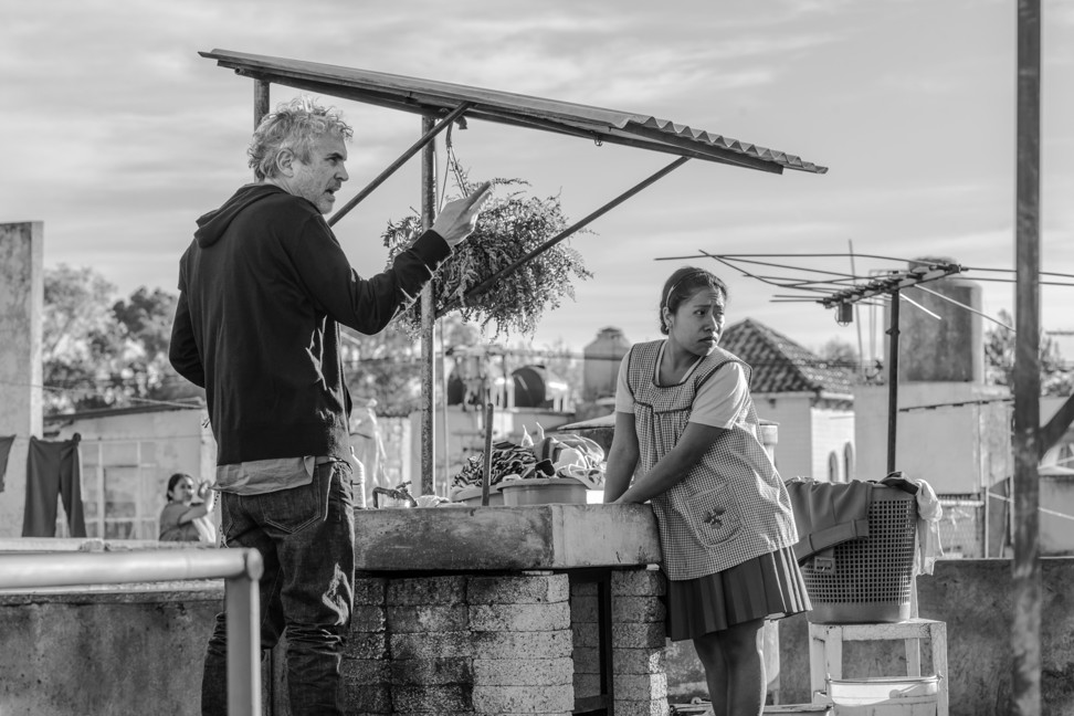 Filmmaker Alfonso Cuarón, left, and Yalitza Aparicio on the set of Roma. Cuaron was nominated for an Oscar for best director for his work on the film. Photo: Netflix