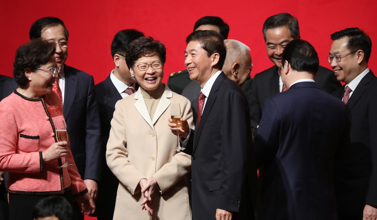 Chief Executive Carrie Lam Cheng Yuet-ngor (second left) shares a laugh with Luo Huining, director of the central government’s liaison office in Hong Kong, at the office’s spring reception at the Convention and Exhibition Centre in Wan Chai on January 15. Photo: Sam Tsang