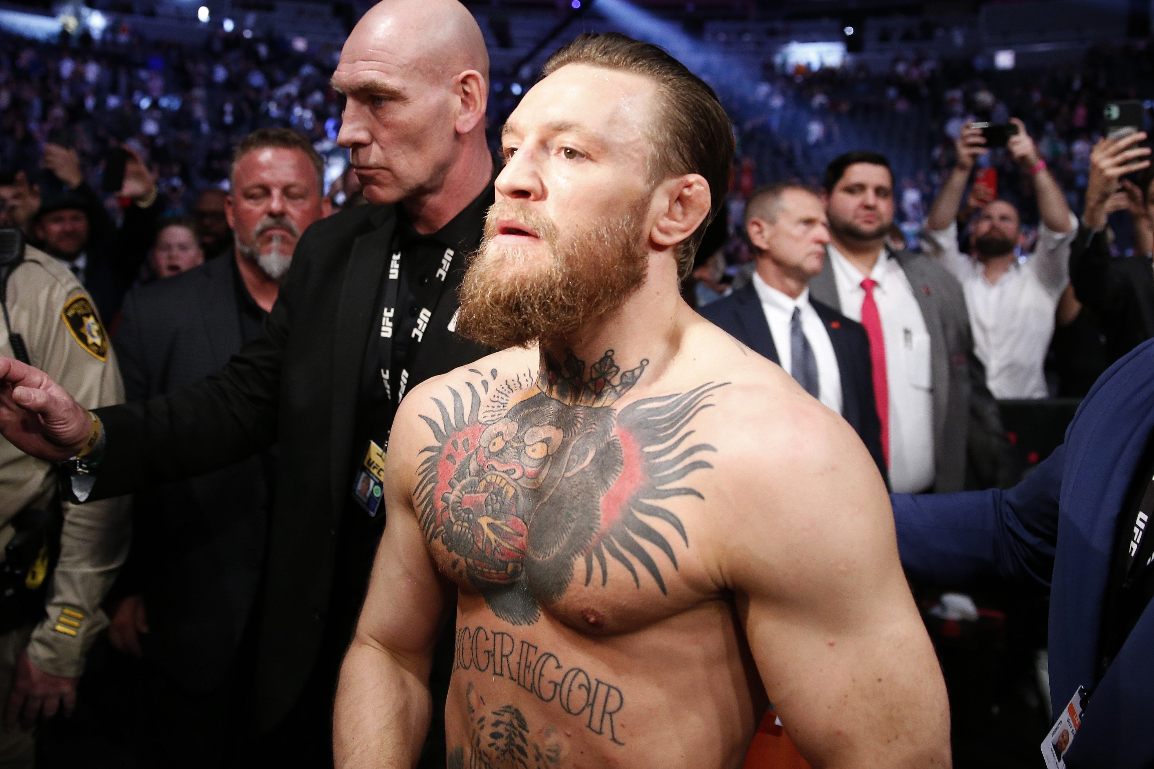 Conor McGregor celebrates his first-round TKO victory against Donald Cerrone as he exits the Octagon. Photo: AFP