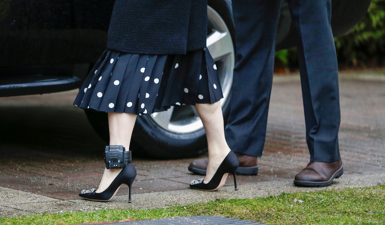 The ankle monitor of Meng Wanzhou is visible above her Manolo Blahnik high heels as she leaves her home on Monday. Photo: Reuters