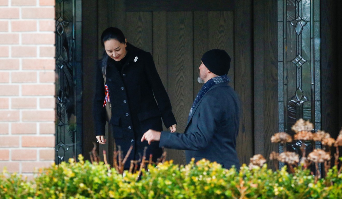 Meng Wanzhou is greeted by a member of her security as she leaves her home to attend the start of her extradition hearing in Vancouver on Monday. Photo: Reuters
