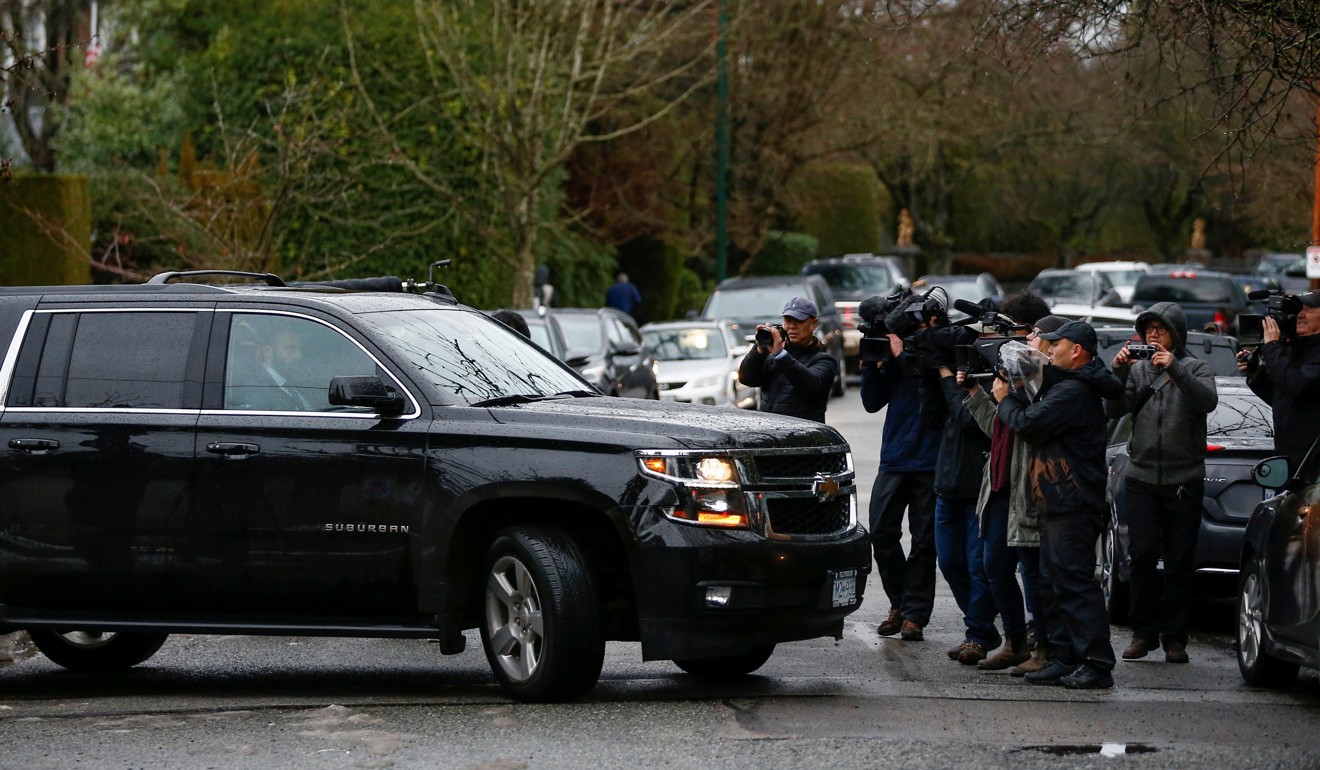 Media photograph the vehicle carrying Huawei Chief Financial Officer Meng Wanzhou from her home to attend the start of her extradition hearing in Vancouver on Monday. Photo: Reuters