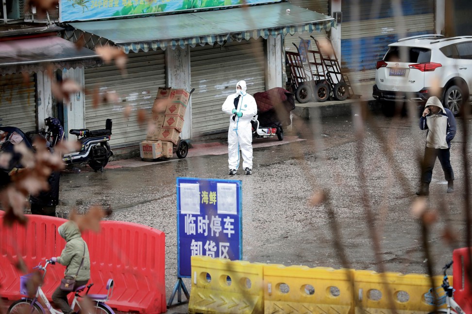 A worker in a protective suit is seen at the closed seafood market in Wuhan on January 10. Photo: Reuters