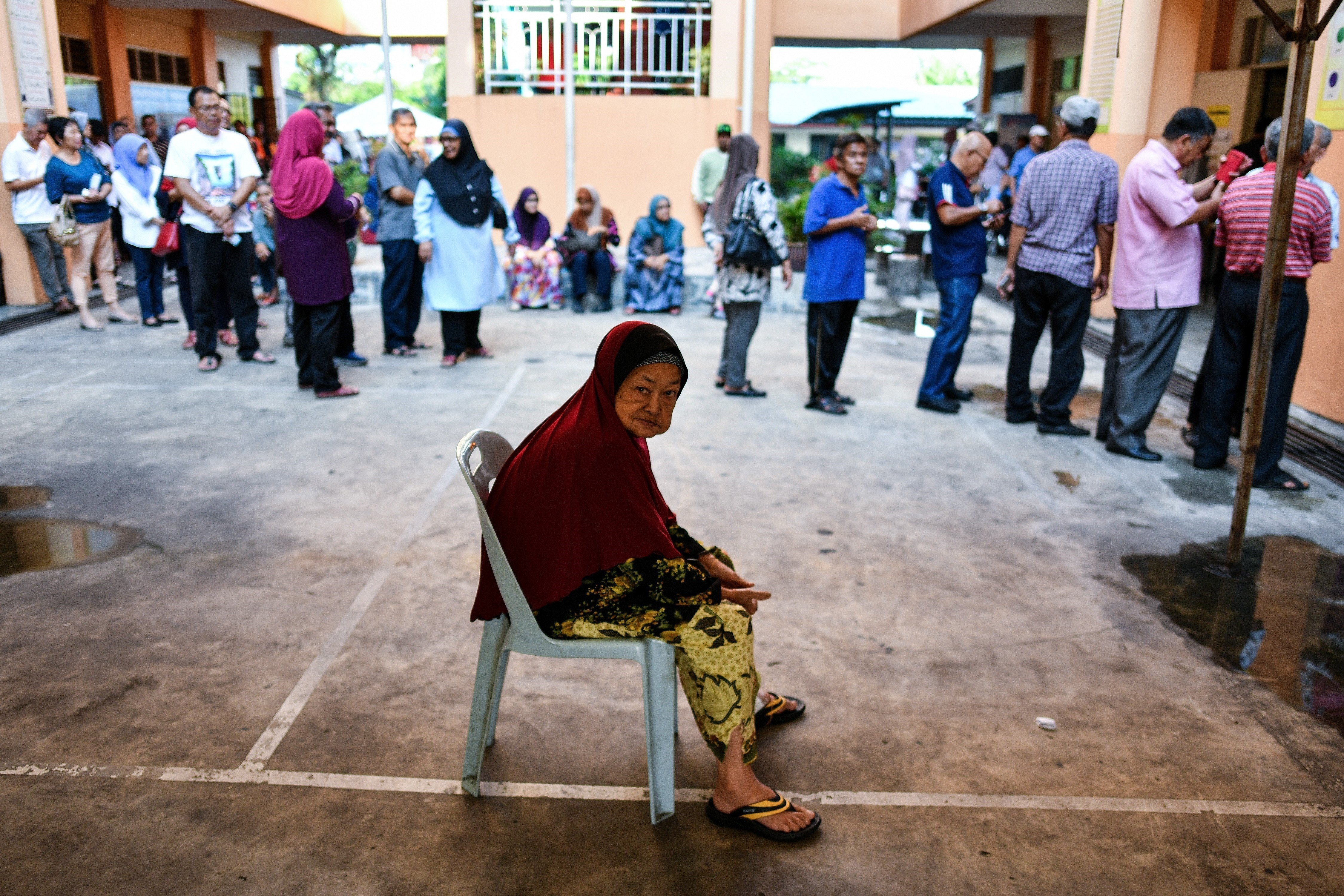 An elderly Malaysian woman waits to cast her vote in Kuala Lumpur during the 2018 general election. Photo: AFP