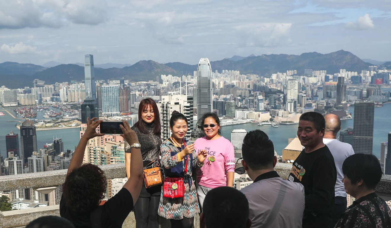 Tourists take photos on The Peak on December 18. Photo: Sam Tsang
