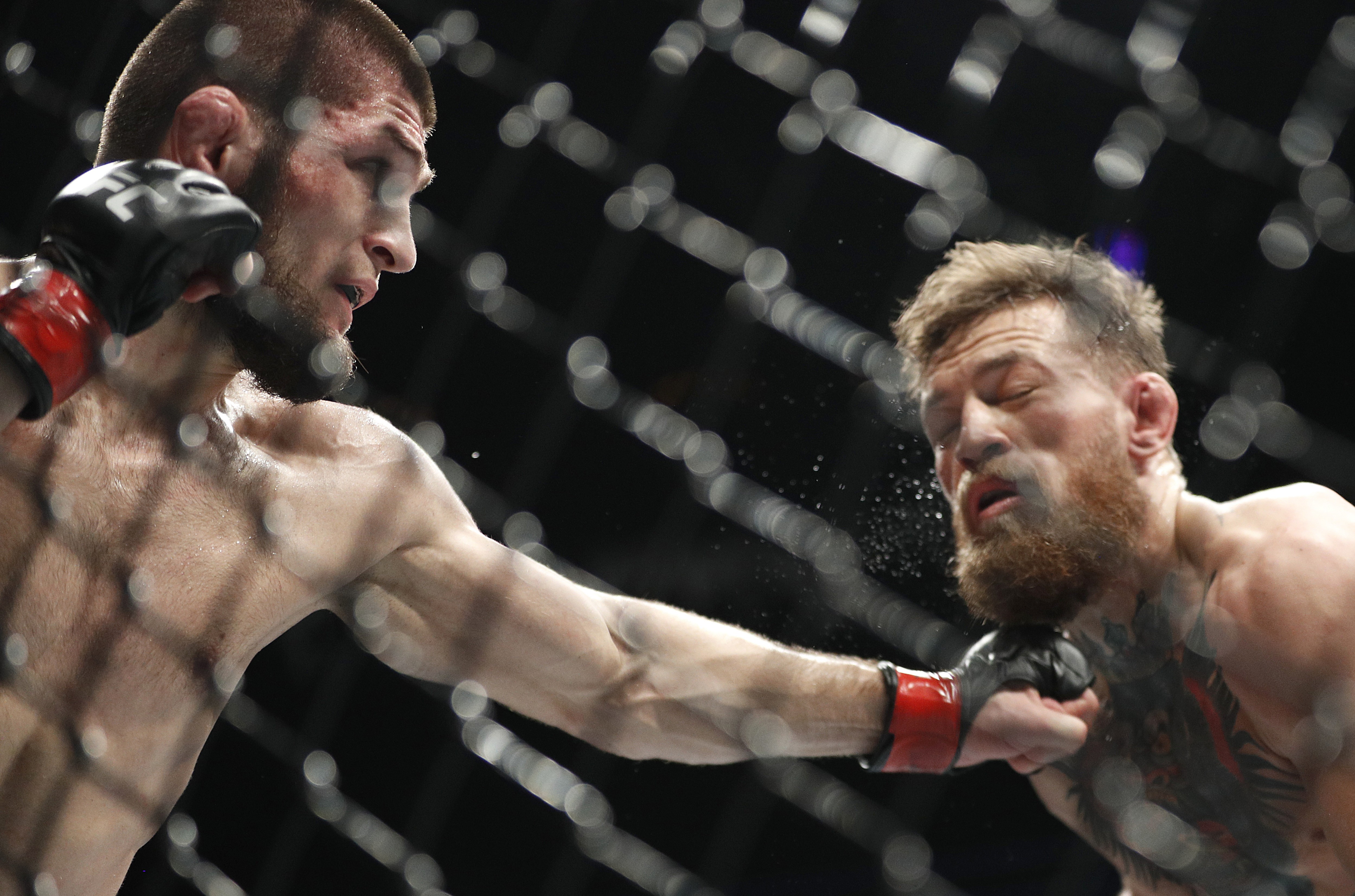 Khabib Nurmagomedov, left, punches Conor McGregor during a lightweight title mixed martial arts bout at UFC 229 in Las Vegas. Photo: AP Photo